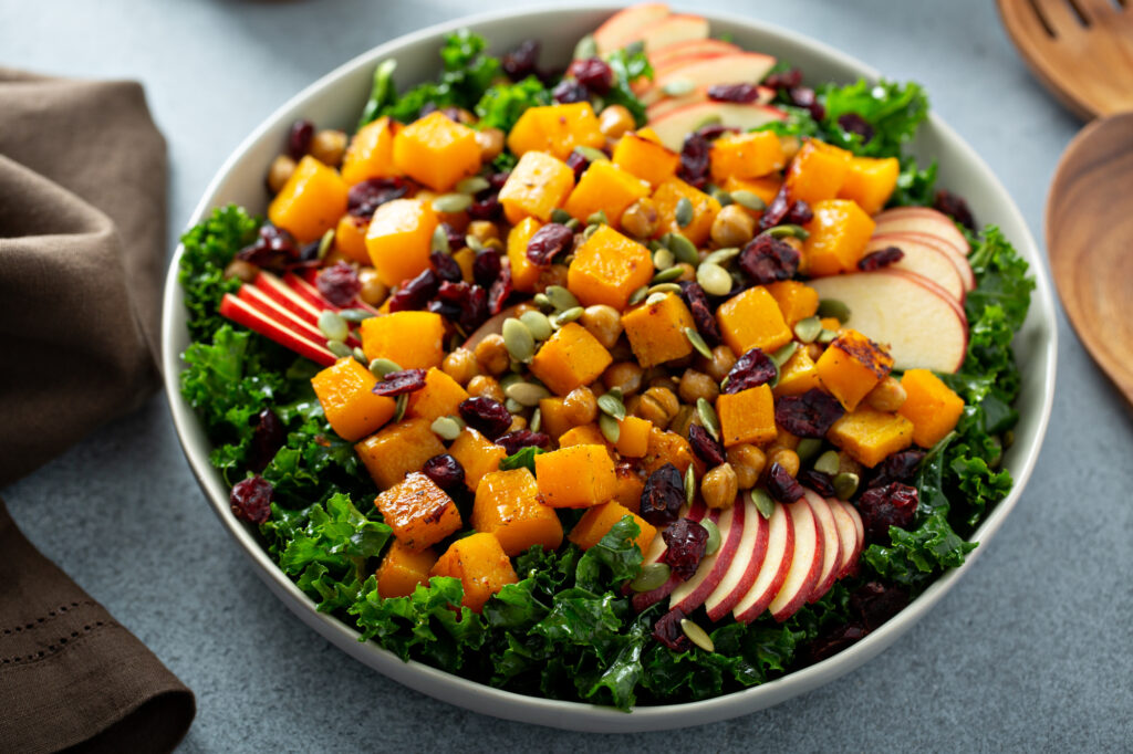 Autumn salad with apples, cranberries, roasted squash, pumpkin seeds and kale. 