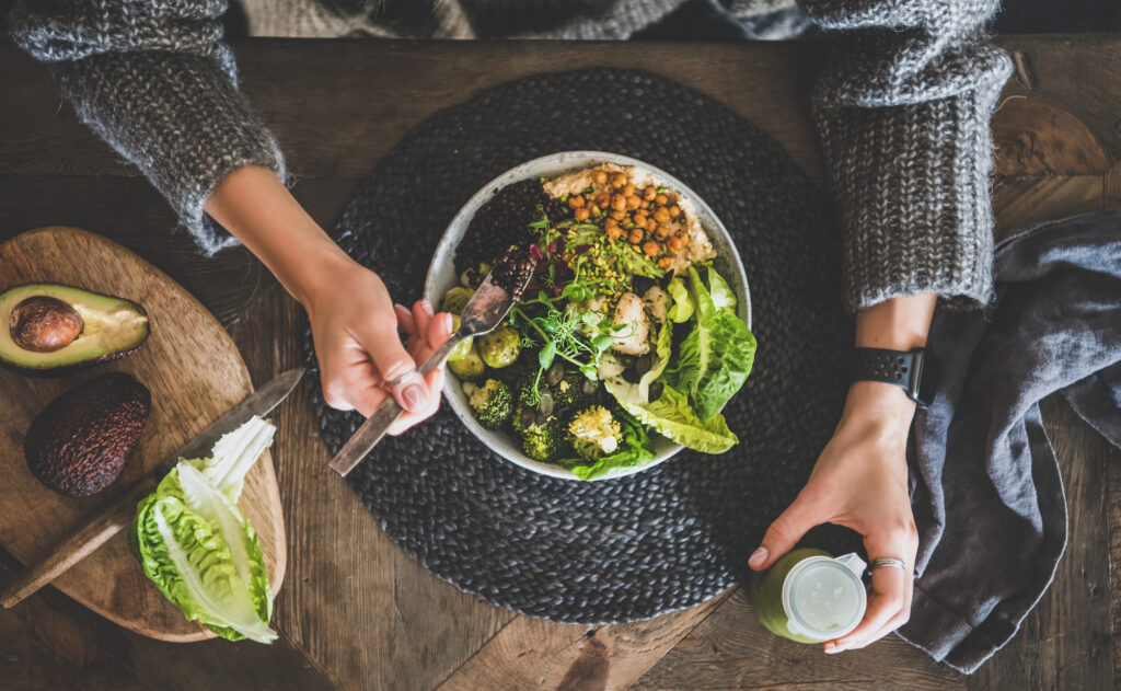 Woman eating plant-based salad. 